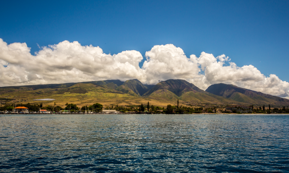 Ocean view looking toward mountains with fluffy clouds