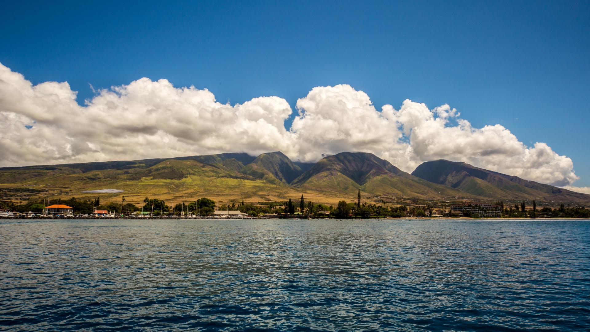 Ocean view looking toward mountains with fluffy clouds
