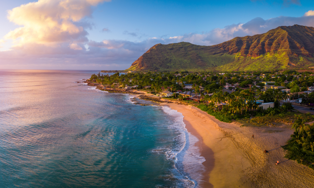Aerial sunset view of coastal beach and mountains