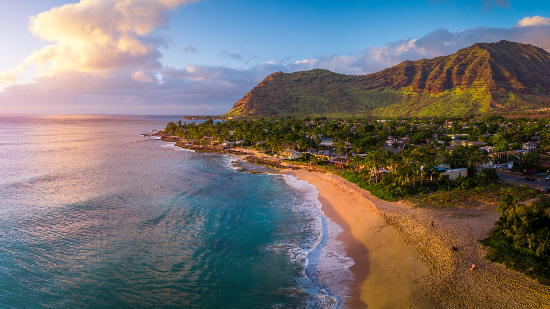 Aerial sunset view of coastal beach and mountains
