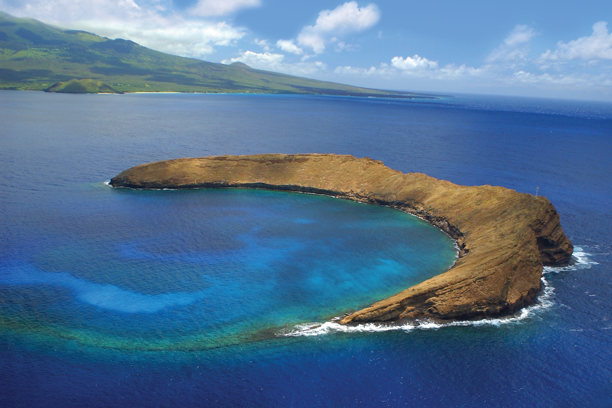 Aerial view of Molokini crater’s clear turquoise reef waters off Maui’s shore